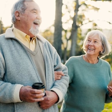 Senior couple, park and morning walk with conversation, love and bonding together with health. Wellness, marriage and retirement with outdoor, communication and coffee on urban garden path on date